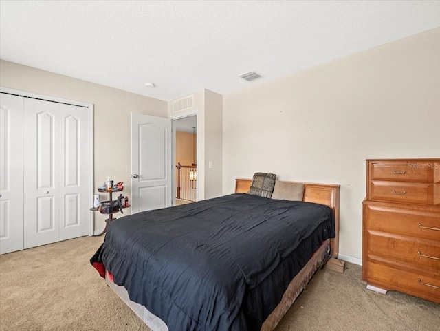 bedroom with light carpet and a closet