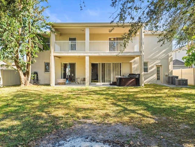 back of house with a patio, a yard, central AC unit, and a balcony