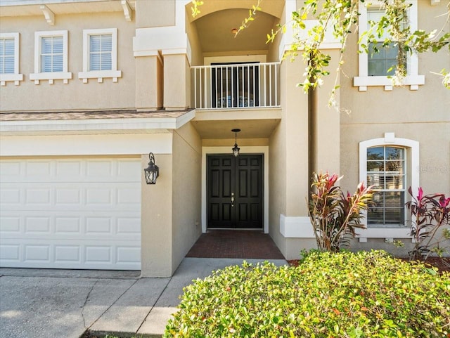 property entrance featuring a balcony and a garage