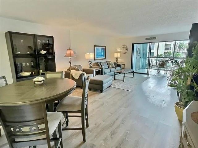 dining room featuring light hardwood / wood-style flooring and a textured ceiling