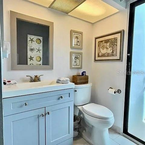 bathroom with tile patterned floors, vanity, and toilet