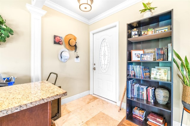 foyer with light tile patterned floors, ornamental molding, and ornate columns