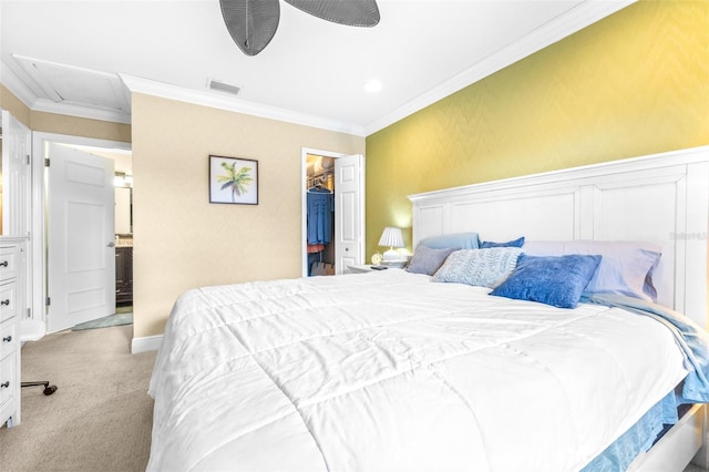 carpeted bedroom featuring crown molding, ceiling fan, a spacious closet, and a closet