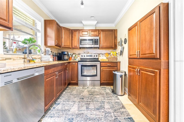 kitchen with backsplash, ornamental molding, light stone countertops, and appliances with stainless steel finishes