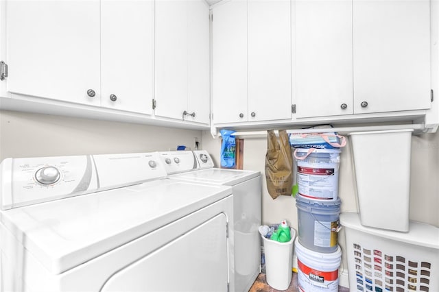 clothes washing area featuring cabinets and washing machine and clothes dryer