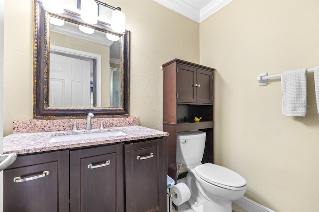 bathroom with ornamental molding, toilet, and vanity