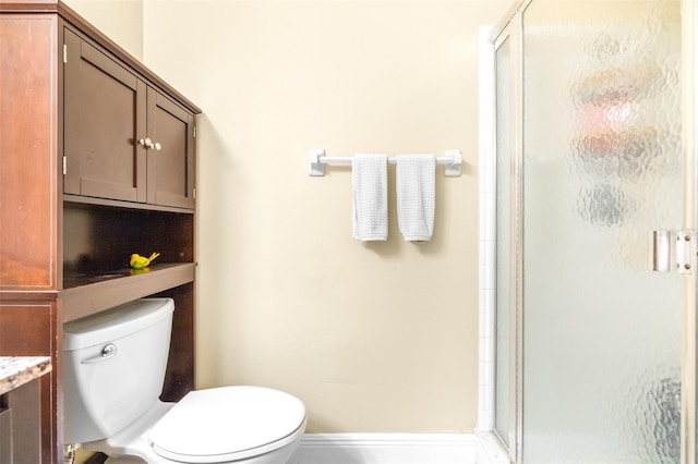 bathroom with vanity, a shower with shower door, and toilet