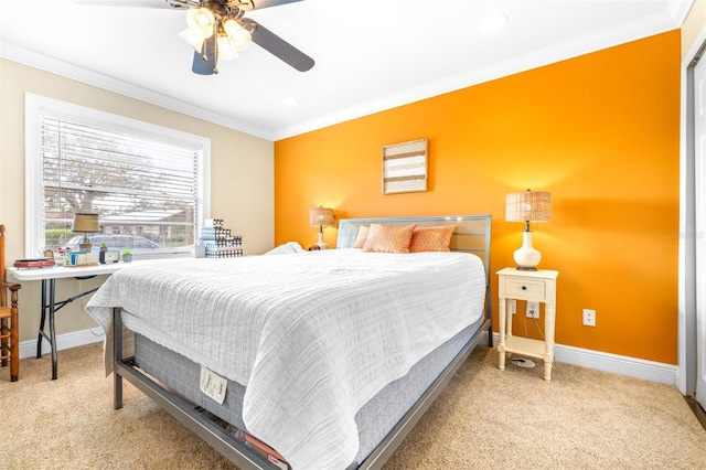 carpeted bedroom featuring ornamental molding and ceiling fan