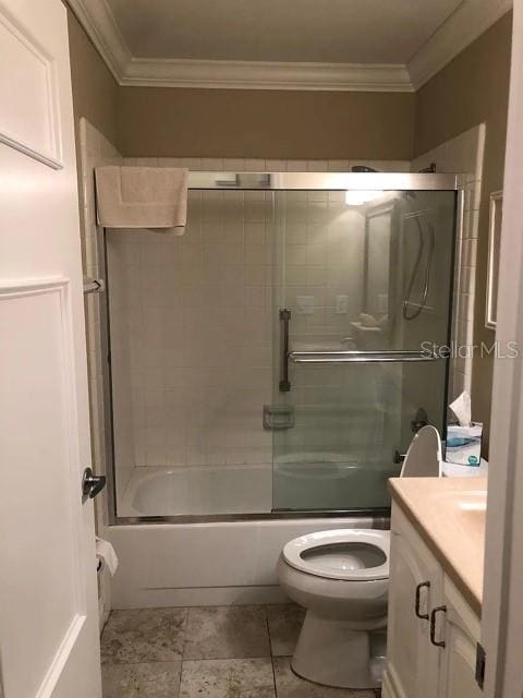 bathroom with crown molding, toilet, bath / shower combo with glass door, and vanity