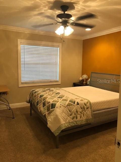 bedroom with crown molding, carpet, baseboards, and ceiling fan