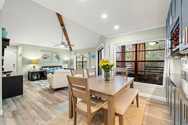 dining room featuring lofted ceiling with beams, ceiling fan, and light wood-type flooring