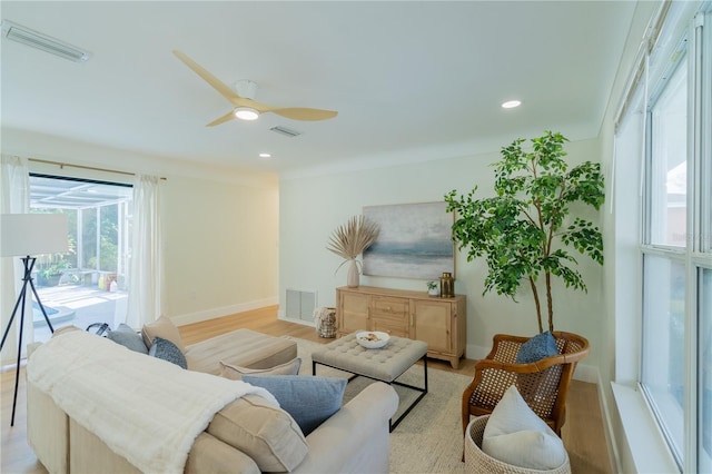 living room with light wood-type flooring and ceiling fan