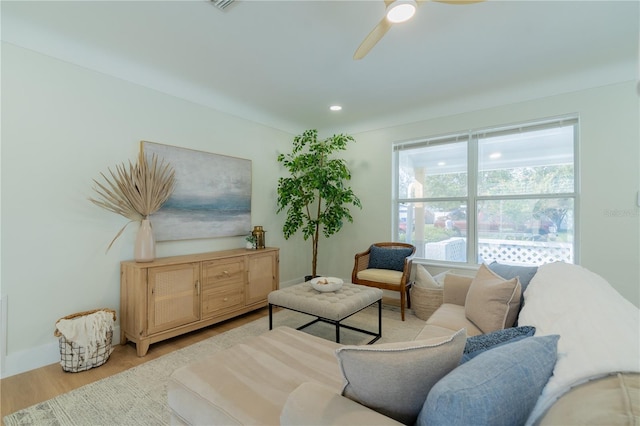 living room featuring light hardwood / wood-style flooring and ceiling fan