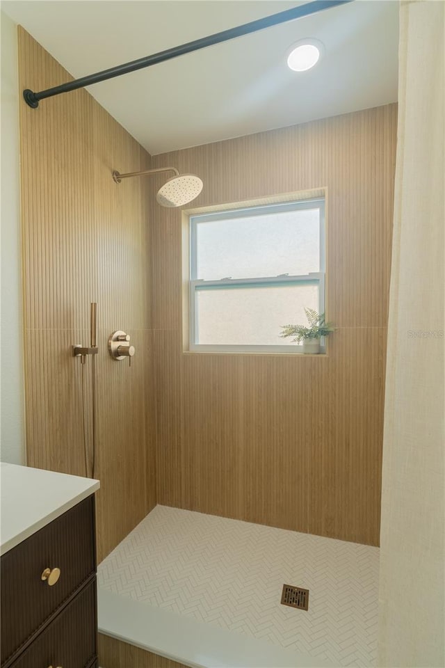 bathroom featuring vanity and a tile shower