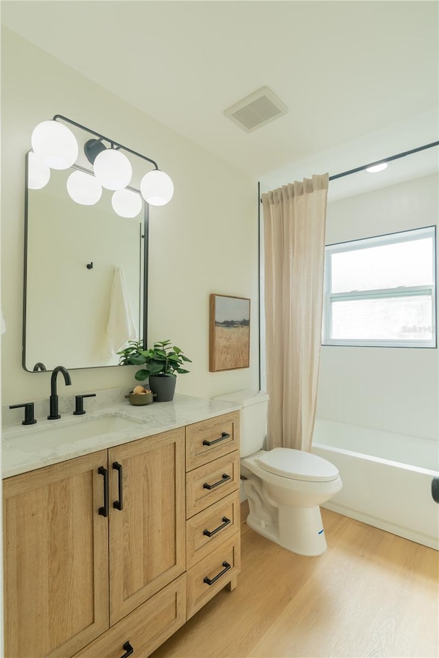 full bathroom with toilet, hardwood / wood-style flooring, vanity, and shower / bath combination with curtain