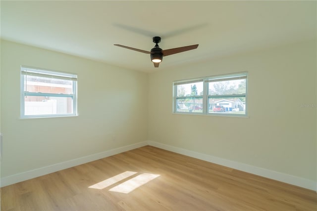 spare room featuring light hardwood / wood-style floors, plenty of natural light, and ceiling fan