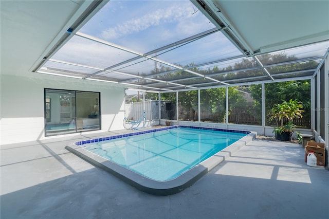 view of swimming pool featuring a patio area and a lanai