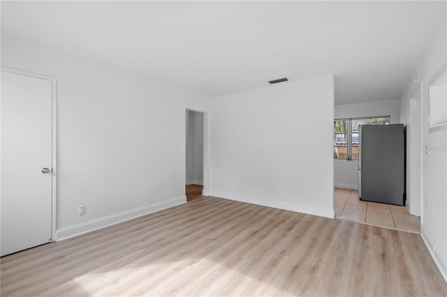 spare room with light hardwood / wood-style flooring