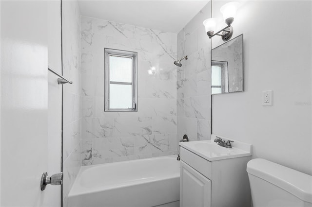 full bathroom featuring toilet, tiled shower / bath combo, and vanity