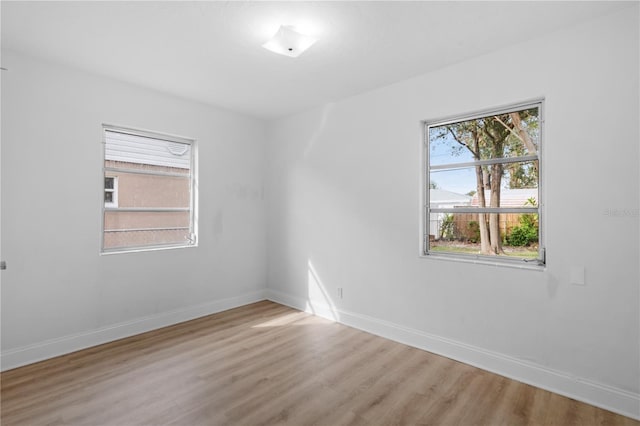 unfurnished room with hardwood / wood-style flooring