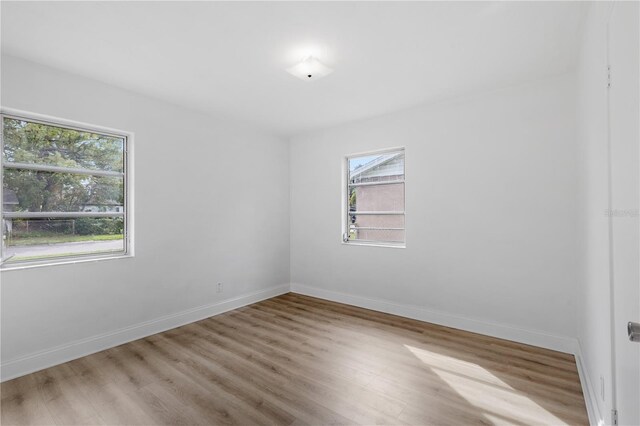 unfurnished room featuring light hardwood / wood-style floors and a healthy amount of sunlight