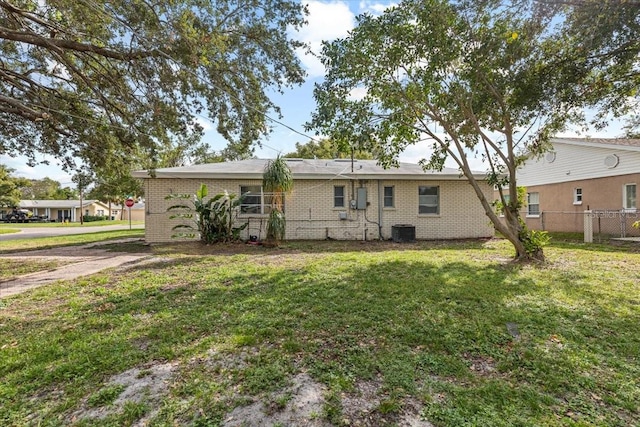 rear view of property featuring a yard