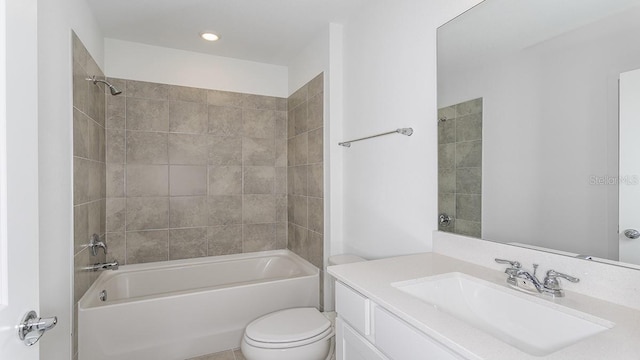 full bathroom with vanity, tiled shower / bath combo, and toilet