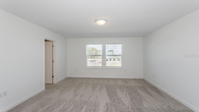 empty room featuring light carpet