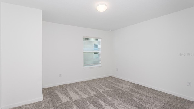 empty room featuring light carpet