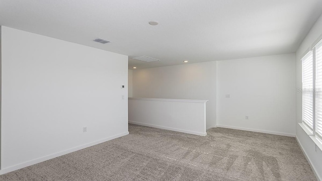 spare room featuring light colored carpet