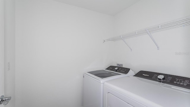 clothes washing area featuring washer and clothes dryer