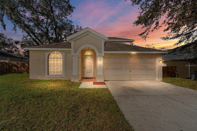 view of front of home featuring a yard and a garage