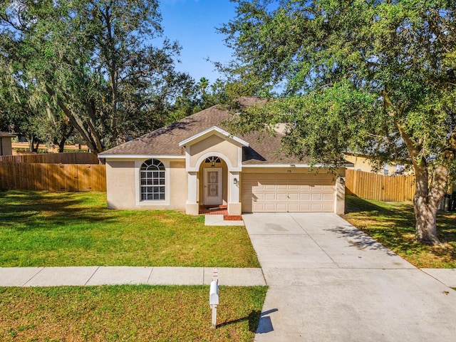 view of front of property with a garage and a front yard