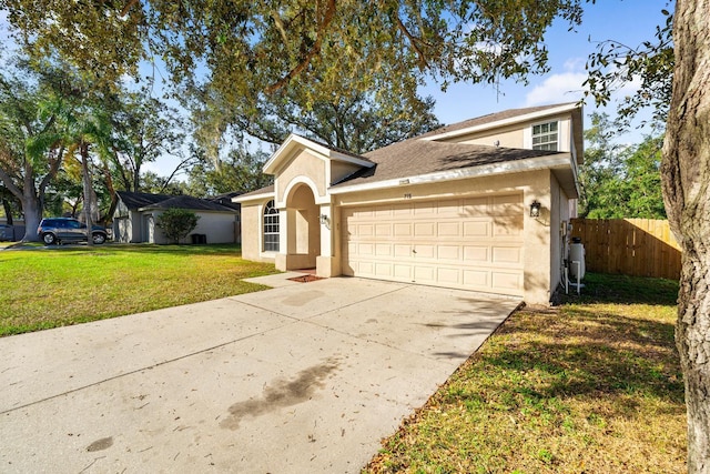 view of front of property with a garage and a front yard