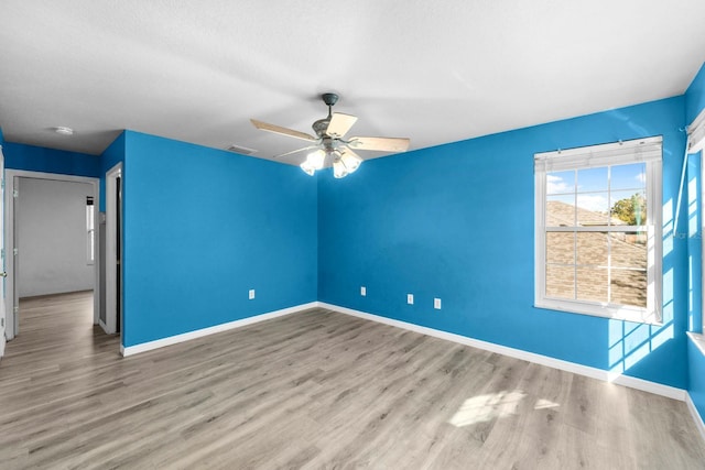 unfurnished room featuring ceiling fan and light wood-type flooring