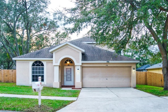 ranch-style home with a garage and a front yard