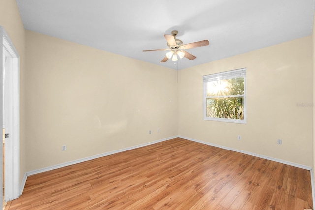 spare room with light hardwood / wood-style flooring and ceiling fan