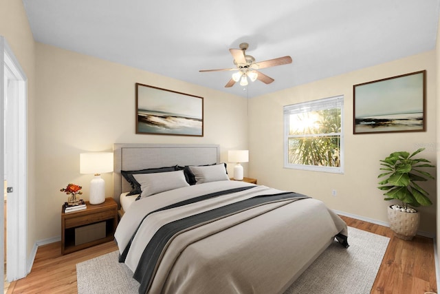 bedroom with ceiling fan and light wood-type flooring