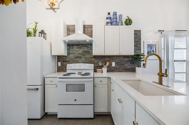 kitchen with wall chimney exhaust hood, sink, backsplash, white cabinetry, and white appliances