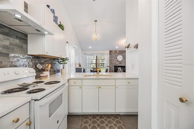 kitchen with vaulted ceiling, white cabinets, exhaust hood, electric range, and a fireplace