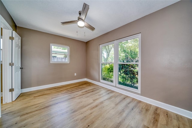 unfurnished room featuring ceiling fan and light wood-type flooring