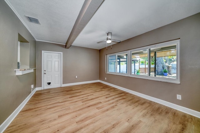 unfurnished room with beam ceiling, light wood-type flooring, and ceiling fan