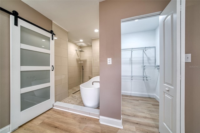 bathroom featuring hardwood / wood-style floors and plus walk in shower