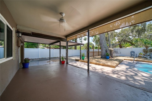 unfurnished sunroom featuring ceiling fan