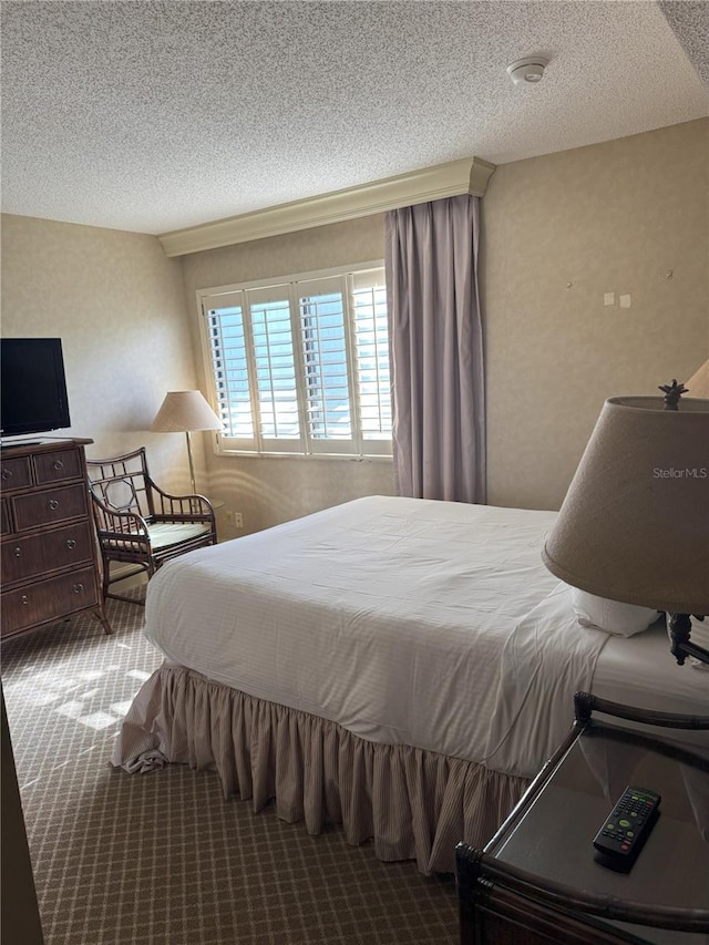 carpeted bedroom with a textured ceiling