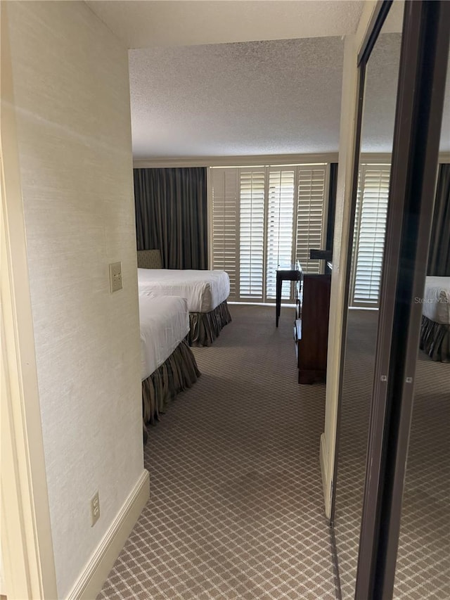 unfurnished bedroom with carpet flooring and a textured ceiling