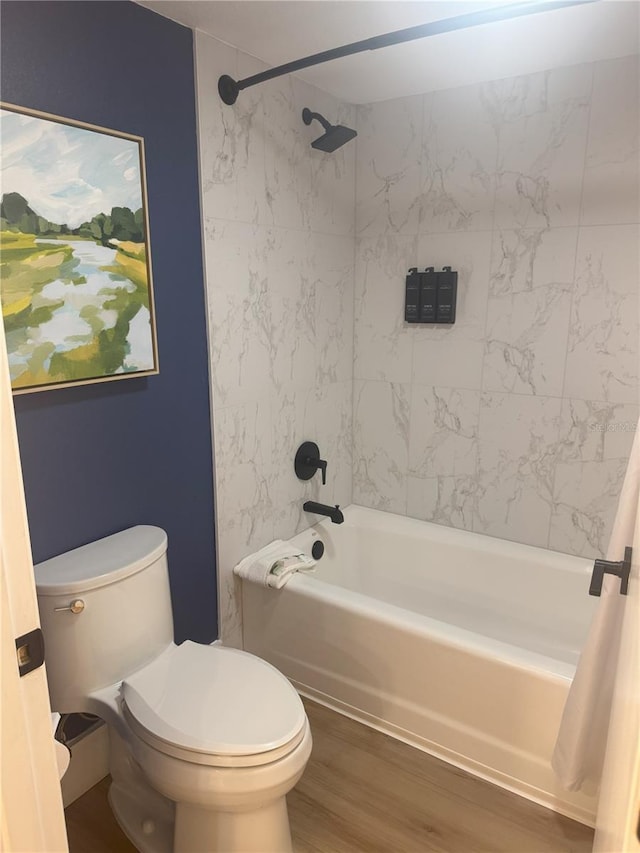 bathroom featuring toilet, wood-type flooring, and shower / tub combo