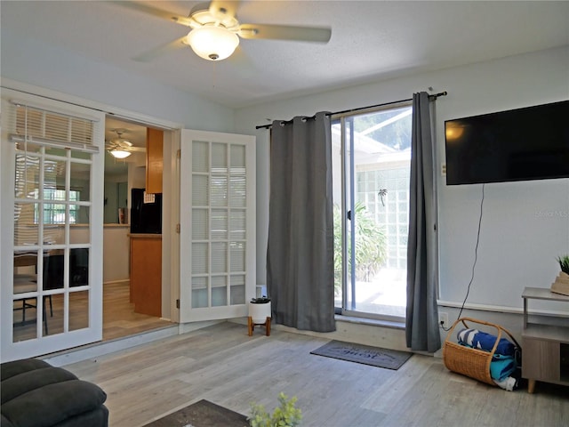 doorway to outside featuring hardwood / wood-style flooring and ceiling fan