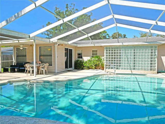 view of pool featuring ceiling fan, glass enclosure, and a patio area