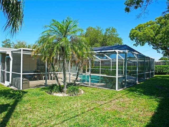 view of pool featuring a patio, a lanai, and a yard